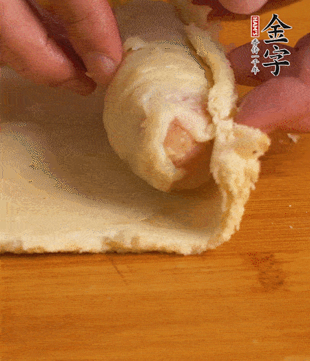 吐司卷起香腸，吐司尾端涂抹少許全蛋液，卷好的吐司表面蘸上蛋液，在裹上一層面包糠，送入預(yù)熱好的烤箱中。